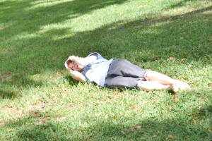 Lisa, with gales of laughter, rolls downhill on the soft grass of the sanctuary at Bok Tower, Florida.